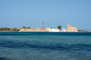 Vendicari, İtalya: 09-15-2022: Arka planda eski tonara bulunan Vendicari plajı