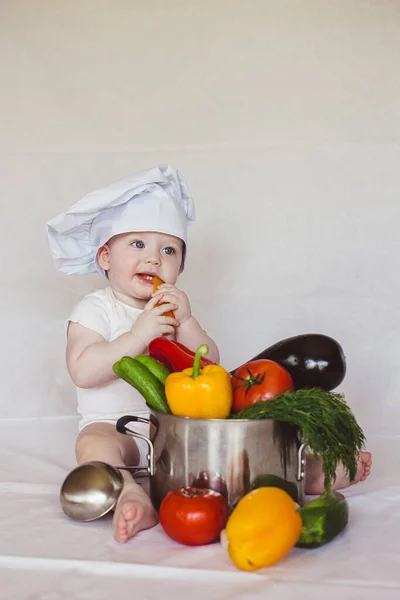 Healthy nutrition Happy little boy in hat prepares a vegetable salad. Cook