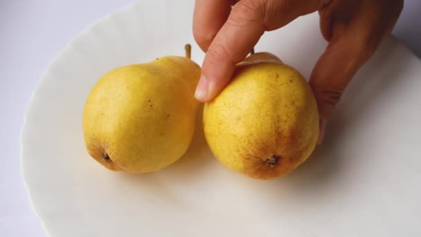 Unrecognizable Hand Places Ripe Juicy Large Yellow Pears White Plate — Stock Video