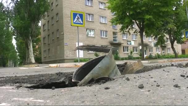 在城市房屋附近的沥青路面上可以看到一个金属外壳 俄罗斯军队正在炮击乌克兰城市 2022年真正的战争中 俄罗斯袭击了乌克兰 — 图库视频影像