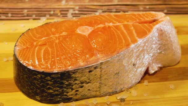 サーモンやサーモンの部分に塩を振りかける 家で赤い魚のステーキを塩 塩辛の赤魚料理 オメガ酸を豊富に含む適切な栄養は — ストック動画