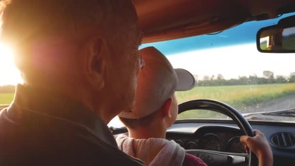Grandfather Teaches Young Grandson Drive Car Boy Sits Wheel His — Stock Video