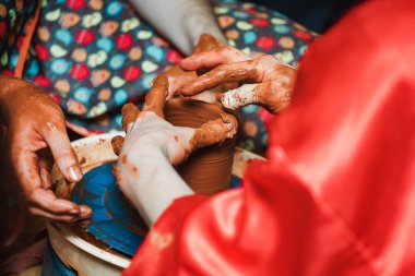 Çömlekçi bir sürahi yapar. Efendinin elleri kille lekelenmiş. Yemeklerin yaratılması üzerine manuel çalışma