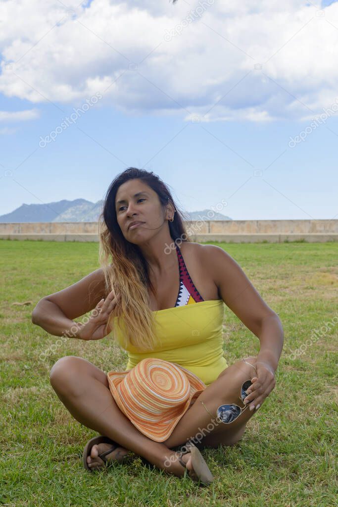 beautiful and happy latin woman with long hair smiling, having a good time, on vacation in mallorca hollidays concept