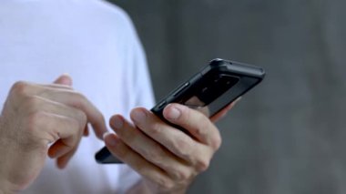 Akıllı telefonu tutan erkek ellerini kapat ve ekran daktilo mesajına dokun