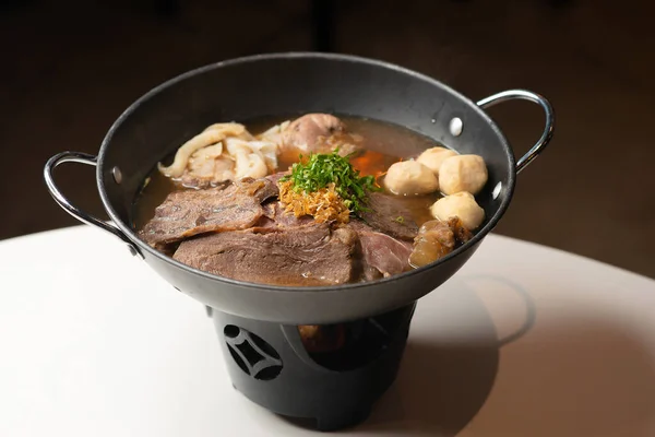 Fine sliced beef in aromatic broth