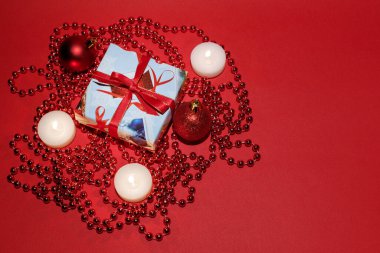 Kırmızı yeni yıl arkaplanında Noel hediyesi. Metin için boş alan