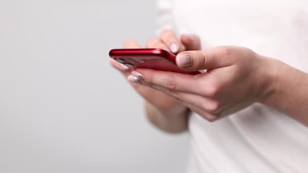 Rode Smartphone Handen Van Een Vrouw Een Witte Achtergrond Close — Stockvideo