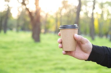 a craft cup of coffee in hand free space for text