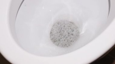 water is flushed into a clean toilet