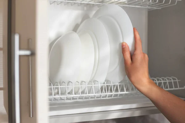 Woman Puts Clean White Plate Kitchen Shelf Close — Stock Photo, Image