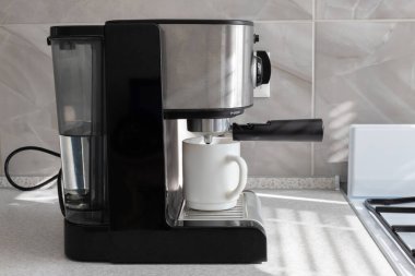 coffee machine with a cup of coffee in the kitchen of the house