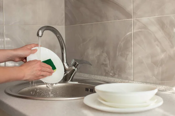 washing dishes in the sink in the kitchen. cleaning, hygiene