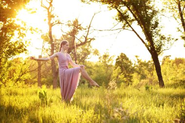 a woman dancer in nature dances in the summer. postcard. Banner