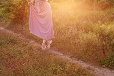 Doğada sivri uçlu ayakkabılı bir kadının bacakları yakın plan. Pankart