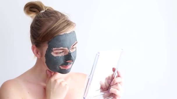 Woman Medical Clay Mask Her Face Looks Mirror White Background — Stockvideo