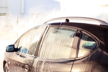 black car in the water at the sink close-up