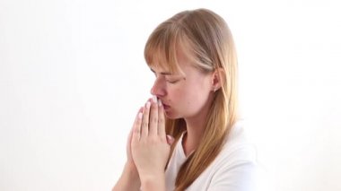 a woman prays and asks for help on a gray background