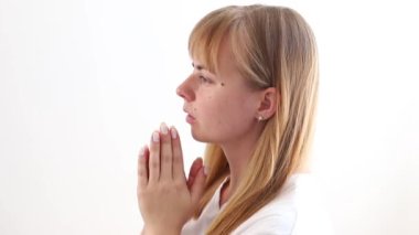concentrated woman praying on white background