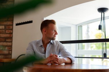 Handsome man looking to side, relax profile pose with natural face with confident smile.