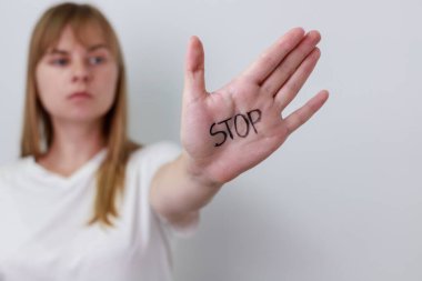 Close up view of young woman making stop gesture with her hand.