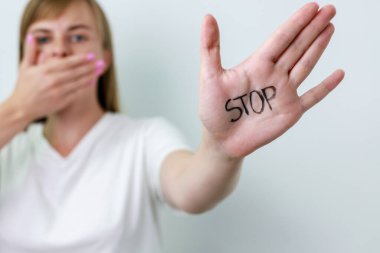 Crying showing a stop sign with her hand