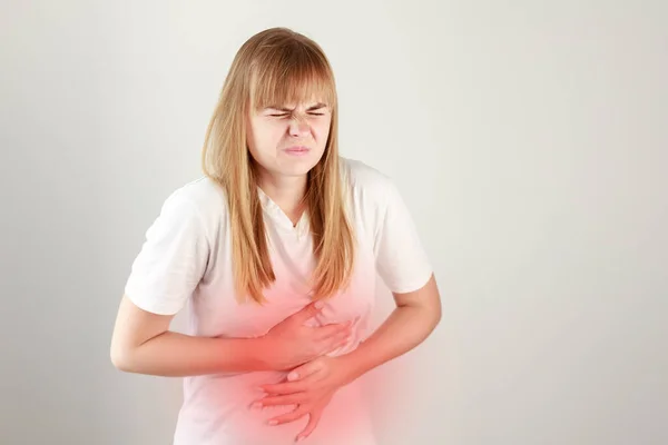 The woman has a severe stomachache. acute pain in the abdomen