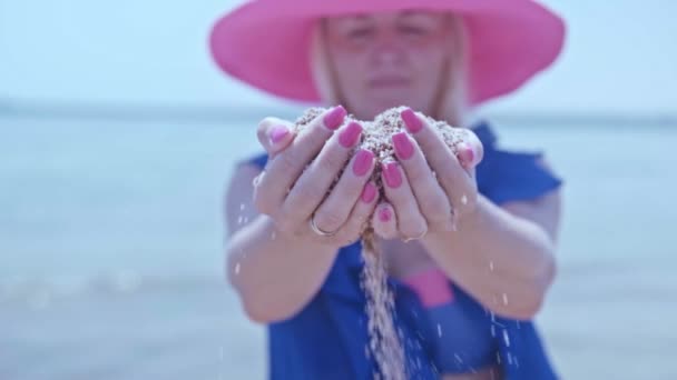 Girl Blue Pareo Pink Hat Throws Sand Her Fingers Seashore — Video Stock