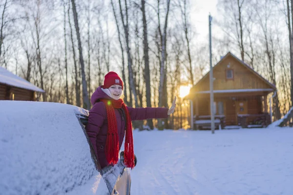 Νεαρή Γυναίκα Ένα Κόκκινο Καπέλο Κρυφοκοιτάζει Έξω Από Ένα Χιονισμένο — Φωτογραφία Αρχείου