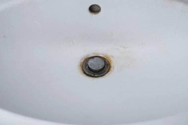 The washbasin is dirty, unhygienic, and has scale and rust. kitchen cleaning concept. dirty domestic bath drain sink.             