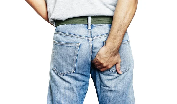 Man hand holding her bottom because having Abdominal pain and Hemorrhoids, Man suffering from hemorrhoid on white with clipping path, closeup. Unhealthy bowel illustration and constipation.           