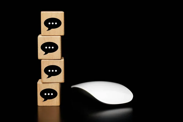 chat message icon on wooden block with mouse White computer, Online communication concept.    