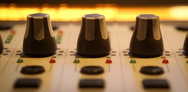 Sound recording studio mixing desk. Music mixer control panel. Closeup.