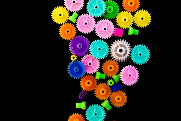 Colorful gears on a black background,concept of work process movement gears