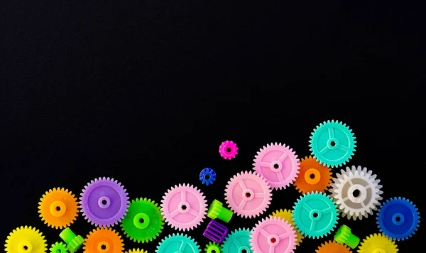 Colorful gears on a black background ,concept of work process movement gears