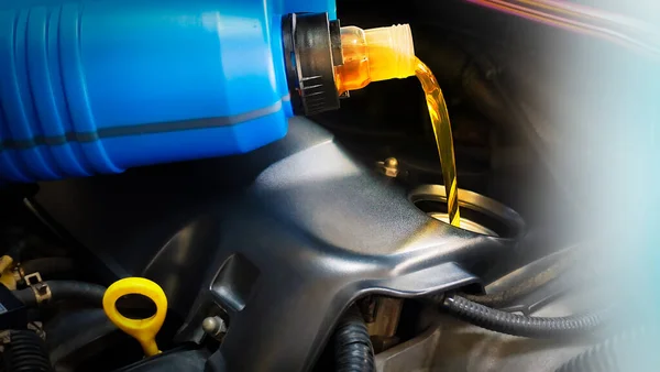 Refueling and pouring oil quality into the engine motor car Transmission and Maintenance Gear .Energy fuel concept.Engine maintenance.                     