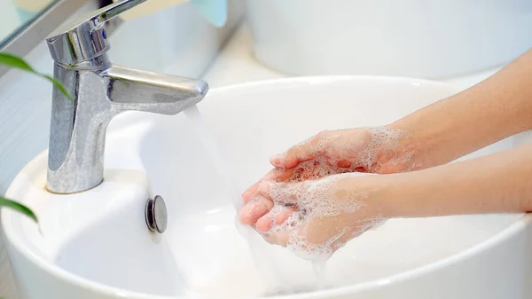 Hygiene concept Wash your hands with soap in the sinkfor covid-19 prevention, hygiene to stop spreading coronavirus.