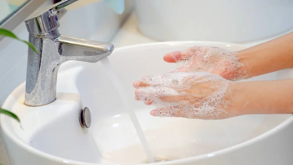 Hygiene concept Wash your hands with soap in the sinkfor covid-19 prevention, hygiene to stop spreading coronavirus.