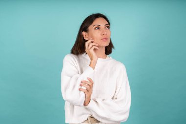 Beyaz, sıcak kazaklı, mutlu, düşünceli bir kadın. Gülümseyerek bak.