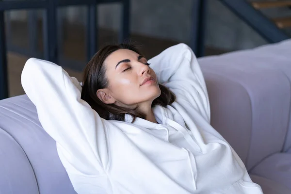 Young Woman Home White Hoodie Couch Serenely Sits Closed Eyes — Stock Photo, Image