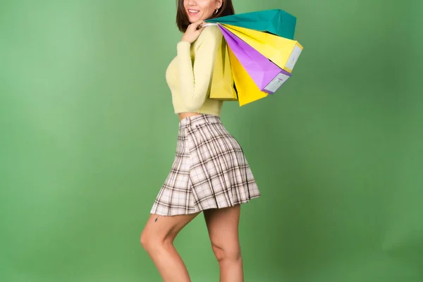 Young Woman Green Background Yellow Sweater Plaid Skirt Holding Shopping — Stock Photo, Image