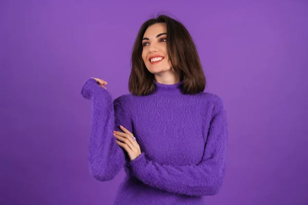 紫の柔らかい居心地の良いセーターの若い女性が陽気にかわいい笑顔を背景に 高い精神で 自信を持って笑顔 口紅と明るいメイク — ストック写真