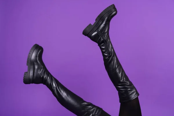 Beautiful Long Thin Legs High Leather Black Boots Purple Background — стоковое фото