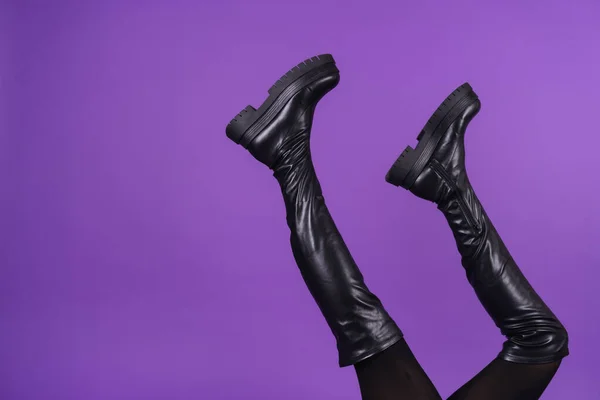 Beautiful Long Thin Legs High Leather Black Boots Purple Background — стоковое фото