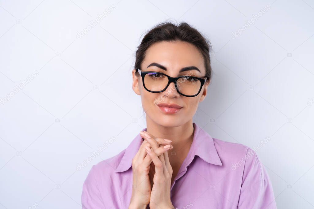 Young woman in a lilac shirt on a white background in glasses for vision cheerful positive in a good mood