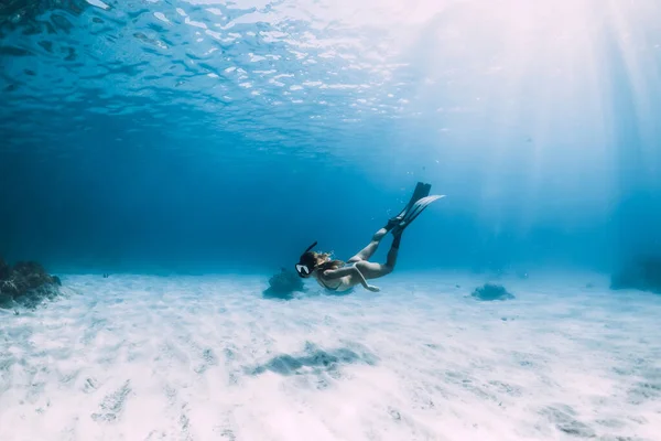 Woman Freediver Glides Fins Sandy Bottom Underwater Blue Ocean — стоковое фото