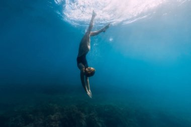 Woman dive in blue sea. Freediving and beautiful lady in ocean