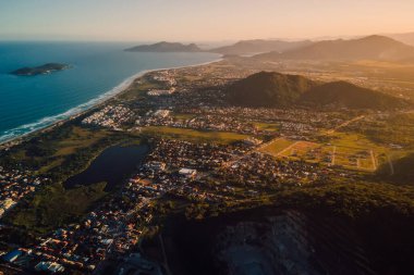 Ocean coastline and town with sunset lights in Campeche, Florianopolis