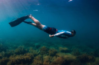 August 07, 2021. Varna, Bulgaria. Men freediver dive with fins in sea. Freediving underwater in transparent sea