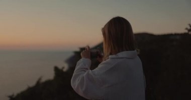 Woman outdoor photography nature on smartphone. Girl shooting on mobile phone